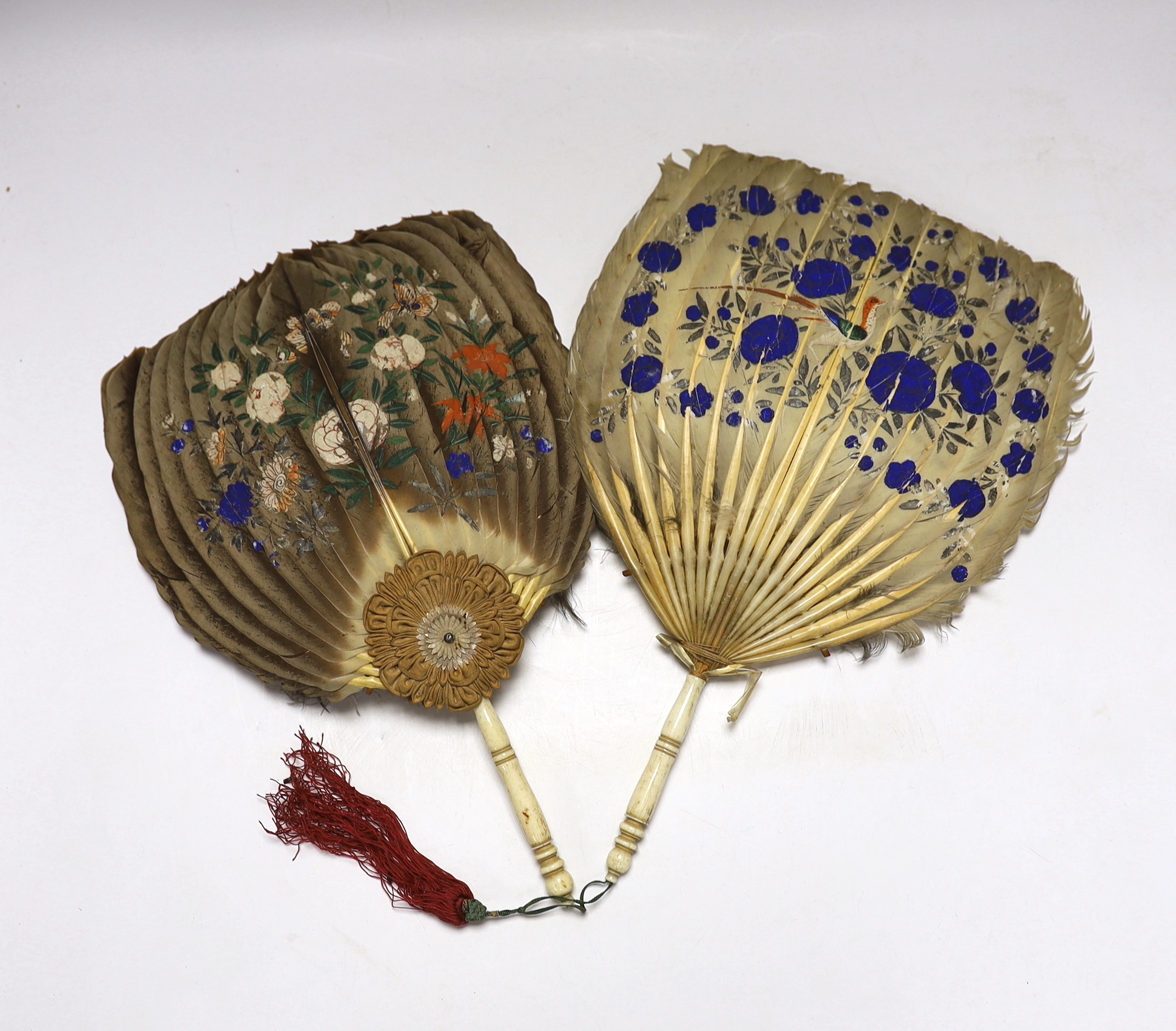 Two feather and bone handled Regency feather fans, the feathers hand painted with Chinese figures one side and flowers the other, one fan has silk rosettes with mother of pearl and feather ornamentation to the top of the